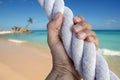 Man hand grab grip adventure paradise beach rope Royalty Free Stock Photo