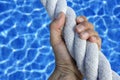 Man hand grab grip sport blue pool big rope Royalty Free Stock Photo