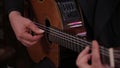 Man hand guitar strings strummed