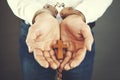 Man hand handcuffs with cross Royalty Free Stock Photo