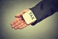 Man hand hiding tax card in a sleeve of a suit. tax evasion economy concept Royalty Free Stock Photo