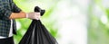 Man hand hold black trash bag to go to throw in the bin Royalty Free Stock Photo