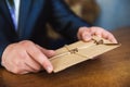 Man hand hold envelope on the wooden background Royalty Free Stock Photo