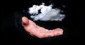 Man hand hold in levitation a clouds on black background