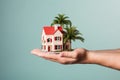 man hand hold miniature house in a palm