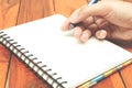Man hand hold a pen writing on the notebook Royalty Free Stock Photo