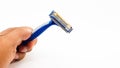 Man hand hold three knives of razor in dark blue color Royalty Free Stock Photo