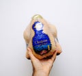 Man hand holding against white background fresh Capon Chapon cockerel meat