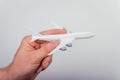 Man hand holding airplane toy model against white background. Protection for pilot and insurance from an exidant. Royalty Free Stock Photo