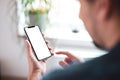 Man hand holding the black smartphone with big blank screen and modern frame less design Royalty Free Stock Photo