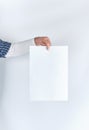 man hand holding a blank rectangular white paper sheet