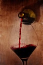 Man hand holding Bottle pouring red wine filling Glass on arty background Royalty Free Stock Photo