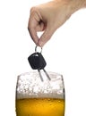 Man hand holding car keys over glass of beer isolated on white Royalty Free Stock Photo