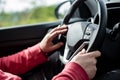 Man hand holding car steering wheel - Male hand close up shallow dof depth of field driving car - Both mans hands on steering Royalty Free Stock Photo