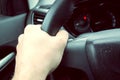 Man hand holding car steering wheel - Male hand close up shallow dof depth of field driving car - Hands on steering Royalty Free Stock Photo