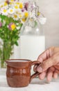 Man hand holding ceramic mug with milk Royalty Free Stock Photo