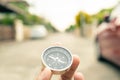 Man hand holding compass on city and car blurred background Using wallpaper or background travel or navigator image