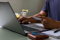 Man hand holding credit card and typing on laptop computer for safe online payment and electronic money transfer security. Royalty Free Stock Photo