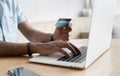 Man hand holding credit card and using laptop at home, Businessman or entrepreneur working on computer in office, Royalty Free Stock Photo