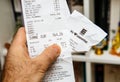 Man hand holding Edeka food supermarket printed receipt
