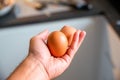 Man hand holding egg on blurred background