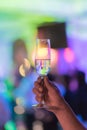 Man hand is holding a glass of white wine in night party Royalty Free Stock Photo