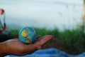 man hand holding globe on mountain earth love concept world care day