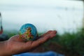 man hand holding globe on mountain earth love concept world care day