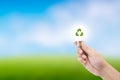 Man hand holding glowing light bulb with recycle symbol