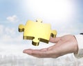 Man hand holding golden puzzle piece Royalty Free Stock Photo