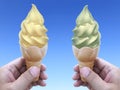 Man hand holding an ice cream cone on background. the blue sky Royalty Free Stock Photo