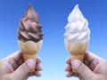 Man hand holding an ice cream cone on background. the blue sky Royalty Free Stock Photo