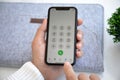 Man hand holding iPhone 11 with call number on screen Royalty Free Stock Photo