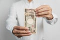 man hand holding Japanese Yen banknote stack. Thousand Yen money. Japan cash, Tax, Recession Economy, Inflation, Investment, Royalty Free Stock Photo