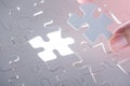 man hand holding jigsaw puzzle pieces , complete jigsaw hole Royalty Free Stock Photo