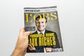 Man hand holding l`Obs magazine with Emmanuel macron on cover