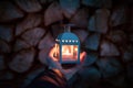Man hand holding lamp with candle. Winter dark background. Old lantern with candle in a nature Royalty Free Stock Photo