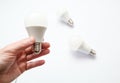 Man hand holding led light bulb on white background. Closeup. Energy saving. Point of view shoot. Energy efficient lighting choice Royalty Free Stock Photo