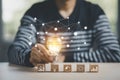 Man hand holding light bulb with Business icon on wood cube and working on desk, Creativity, and innovation are keys to success. C Royalty Free Stock Photo