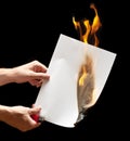 Man hand holding lighter and burned paper Royalty Free Stock Photo