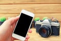 Man hand holding mobile phone blank screen with camera cactus an Royalty Free Stock Photo