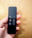 Man hand holding modern Apple TV 4k remote control