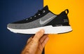 Man hand holding new Nike Running Shoe Odyssey React Shield