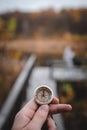 Man hand holding a old compass with broken glass. Travel concept, path selection, navigation, tourism, hiking. Autumn background. Royalty Free Stock Photo