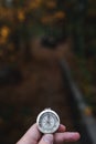 Man hand holding a old compass with broken glass. Travel concept, path selection, navigation, tourism, hiking. Autumn background. Royalty Free Stock Photo