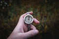 Man hand holding a old compass with broken glass. Travel concept, path selection, navigation, tourism, hiking. Autumn background. Royalty Free Stock Photo