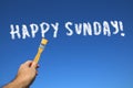 man hand holding paint brush with the text happy sunday
