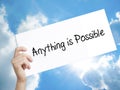 Man Hand Holding Paper with text Anything is Possible . Sign on