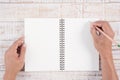 Man hand holding pencil and writing notebook on wood table for Royalty Free Stock Photo