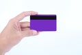 Man hand holding purple credit card or debit card isolated on white background Royalty Free Stock Photo